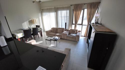 a living room with a couch and a table at Elegant and comfortably furnished 2BRH apartment in a quiet area! in Dubai