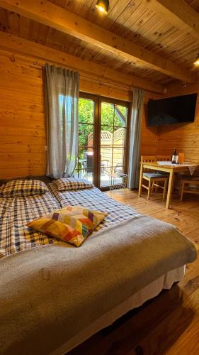 a bedroom with a bed in a log cabin at Andiland in Karwia