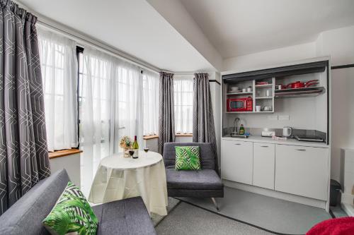 a living room with a couch and a table at Ferryman Studio Apartments in Portsmouth