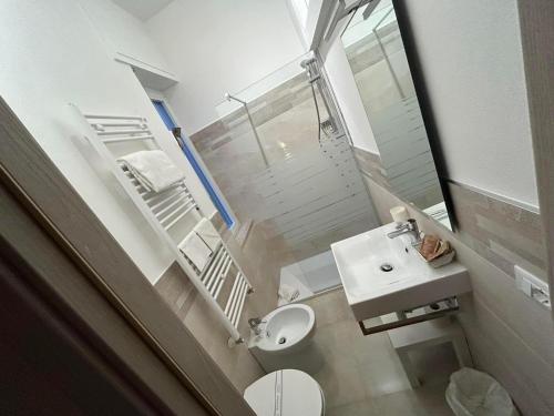 a small bathroom with a sink and a toilet at Piccolo Hotel in Rosignano Solvay