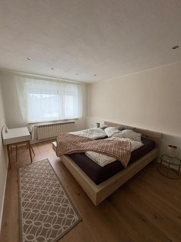 a bedroom with a large bed and a window at Entspannt wohlfühlen! in Gießen