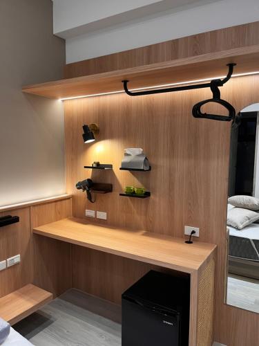 a room with a bed and a desk with a phone at Zao Orange Homestay in Taitung City