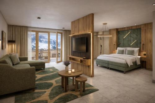 una camera da letto con un letto, un divano e una TV di Kitzhorn Suites a Sankt Johann in Tirol
