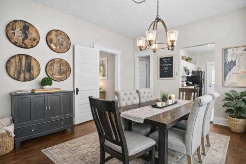 a dining room with a table and chairs at Walkable Historic District Riverview Escape in Jeffersonville
