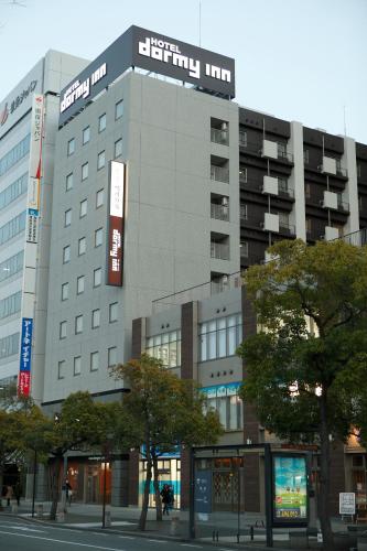 a building with a sign on the side of it at Dormy Inn Premium Wakayama Natural Hot Spring in Wakayama