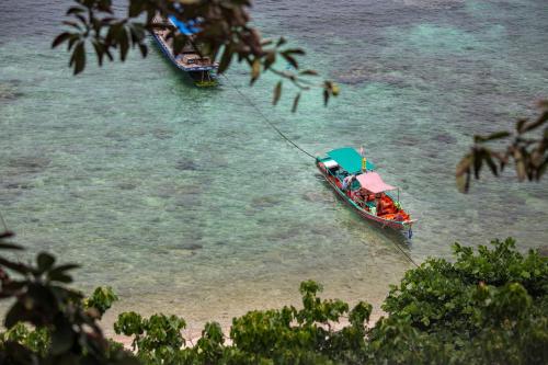 two boats in the water on a beach at Sai Daeng Resort in Koh Tao
