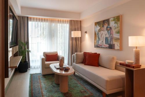 a living room with a couch and a table at Ruins Luxury Resort - Adults Only in Yalıkavak