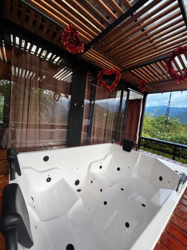 a white bath tub in a room with windows at Cabaña Montecielo San Rafael in San Rafael