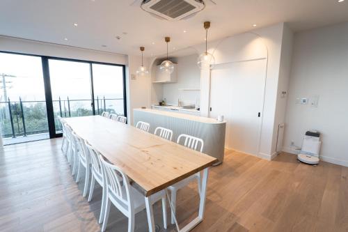 a large dining room with a long table and chairs at villa costa del sol ヴィラ コスタ デル ソル 淡路島 in Awaji