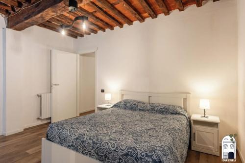 a bedroom with a bed and two night stands at I due Ciueli in Pescia