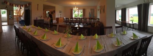 a long table with green vases on it at More Guesthouse in More