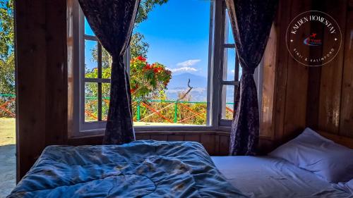 a bed in a room with a window at Kalden Homestay Sinji in Kalimpong