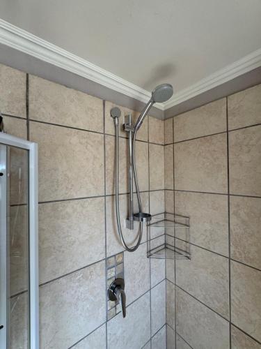 a shower with a shower head in a bathroom at 69 Portobelo in Mossel Bay