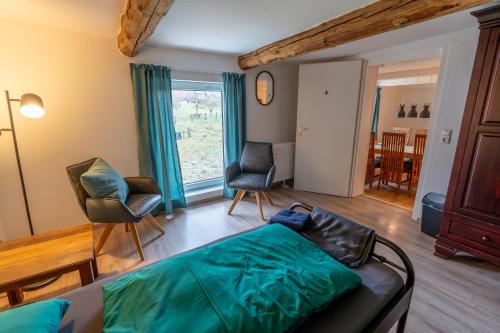 a living room with a couch and two chairs at Ferienwohnung 'Im Hause Hofland' in Uslar