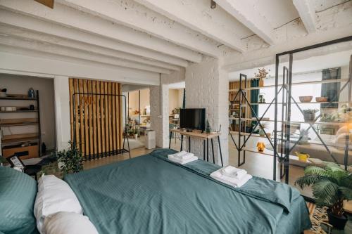 a bedroom with a bed and a tv in it at Studio49apartments Quiet in Niš Free Private Parking Fast WiFi in Niš