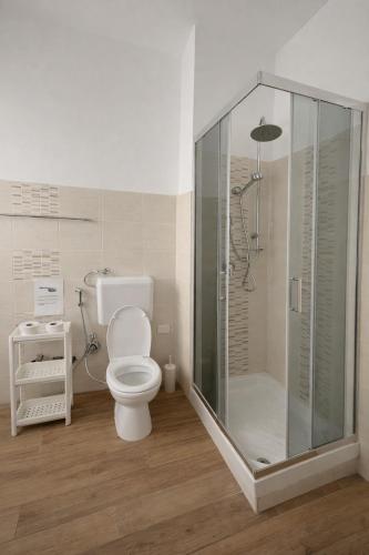 a bathroom with a toilet and a glass shower at Le VELE in Lido di Ostia