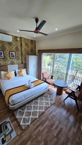 a bedroom with a large bed and a large window at White Dove Luxurious Boutique Hotel, within 3 Km from Guwahati Airport in Guwahati