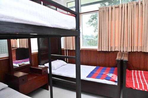 a bedroom with two bunk beds and a window at Hureshan Villa in Negombo