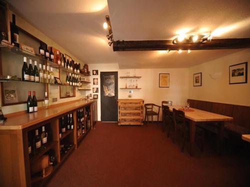 a tasting room with a table and some bottles of wine at Ferienweingut Hammes in Mülheim an der Mosel