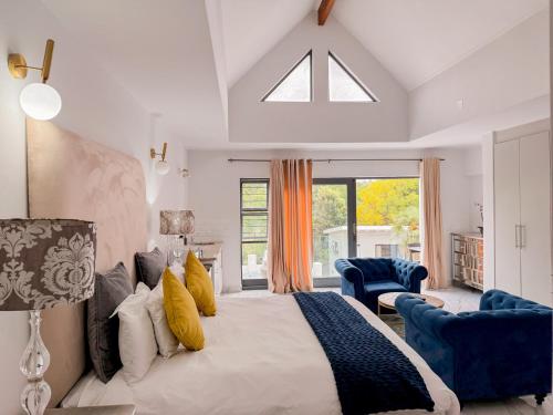 a bedroom with a large bed with yellow pillows at Amoris Guesthouse I - Randburg in Johannesburg