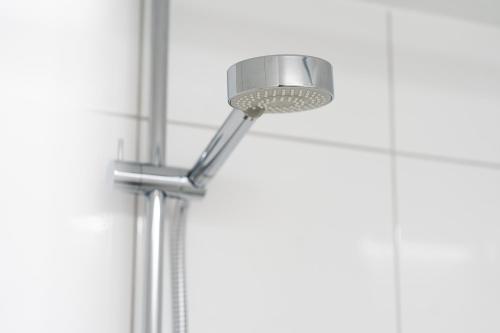 a shower light in a bathroom with white walls at Ferienwohnung 'Im Hause Hofland' in Uslar