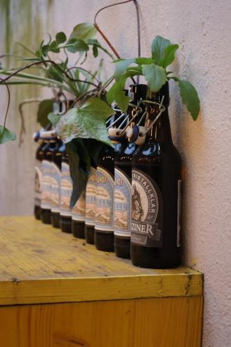 a row of bottles of beer sitting on a shelf at Villa 18 Hostel in Tirana