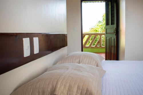 a bedroom with a bed and a view of a porch at Hotel Pousada Dos Ventos in Parnaíba