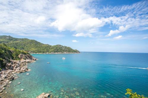 a view of the ocean with boats in the water at Sai Daeng Resort in Koh Tao