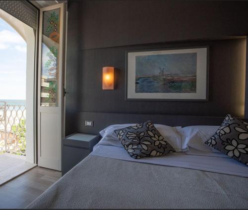 a bedroom with a bed with two pillows at Hotel Imperiale & SPA in Gatteo a Mare