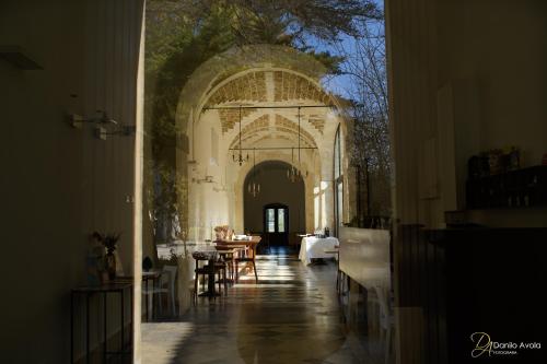 an empty hallway with tables and chairs in a building at Antico Convento Dei Cappuccini in Ragusa