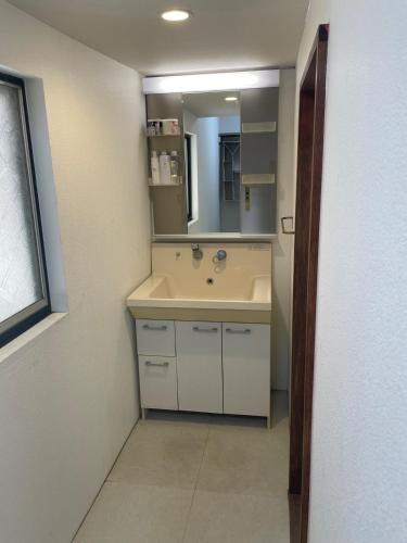 a bathroom with a sink and a mirror at HANARE onomichi in Onomichi