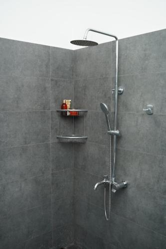 a bathroom with a shower with a shower head at Meadow Breeze in Kandy