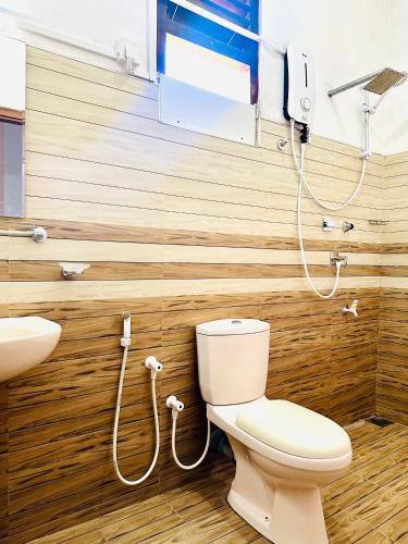 a bathroom with a toilet and a sink at Dreamy Homestay in Anuradhapura