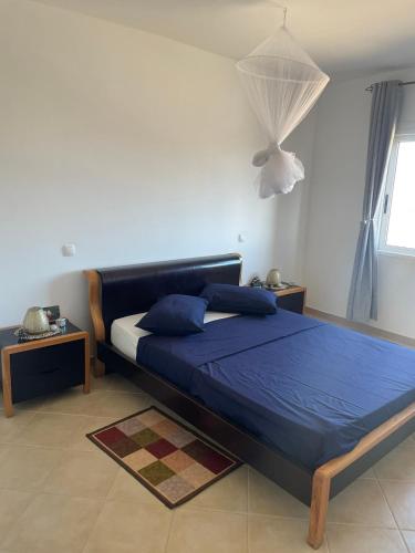 a bedroom with a bed with blue sheets and blue pillows at SOL AZUL in Santa Maria