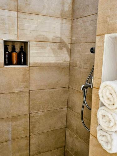 a bathroom with a shower with towels in it at Jemphasis-New Apartments Mykonos in Agios Ioannis Mykonos