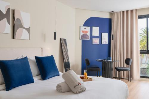 a bedroom with a bed with blue and white at Corner Residence by GoodMove - Casablanca in Casablanca