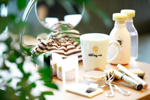 a table with a cup and other items on it at Dormy Inn Premium Wakayama Natural Hot Spring in Wakayama