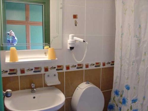 uma casa de banho com um WC, um lavatório e um espelho. em Amos Hotel em Marmaris