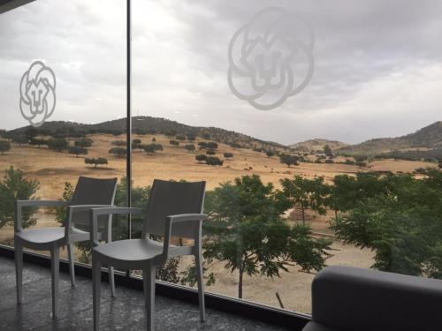 a group of chairs sitting in front of a window at Complejo Leo 24H in Monesterio