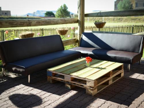a couch and a coffee table on a patio at Hokahanya Inn & Conference Centre in Maseru