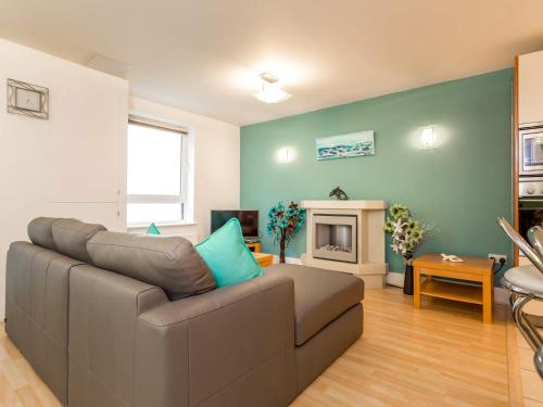 a living room with a couch and a fireplace at Baywatch - Private Balcony Overlooking Poole Quay in Poole