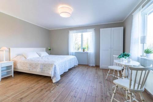 a bedroom with a bed and a table and chairs at KRO803-Haeradsbaeck-Ellagoelshult-4 in Häradsbäck