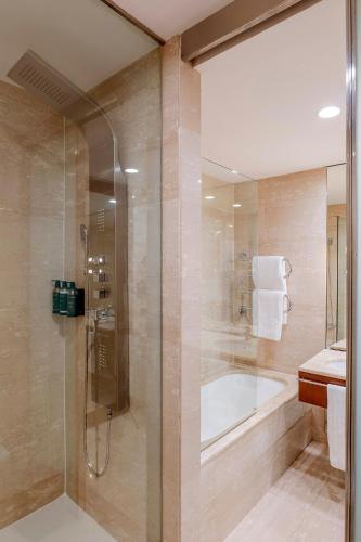 a bathroom with a shower and a tub and a sink at Exe Parc del Vallés in Cerdanyola del Valles
