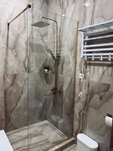 a shower with a glass door in a bathroom at Malishka Eco Villas