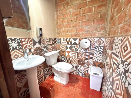 a bathroom with a toilet and a sink at Habitacion Faro in Mazatlán