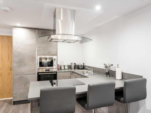 a kitchen with a large island in the middle of a room at Casa Fresa - Castlehill Apartment in Dundee