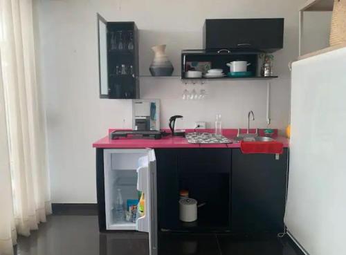 a kitchen with a red counter and a refrigerator at Amazing View From Los Fuertes in Puebla