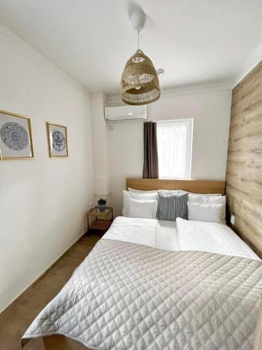 a bedroom with a large white bed in a room at Harmónia Panzió in Bogács