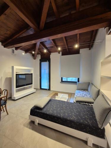 a bedroom with a bed and a flat screen tv at FRANCIACORTA LAKELAND Lodge in Capriolo