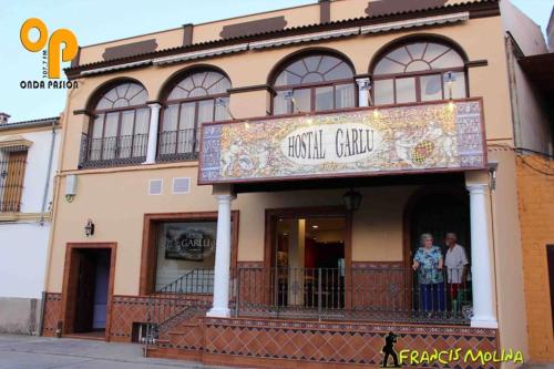 a building with a sign for a music center at Hostal Garlu in La Rambla